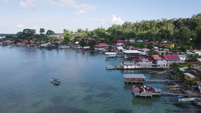 Colorful houses line the shore of Bastimentos Island in Bocas Del Toro, Panama on a sunny day