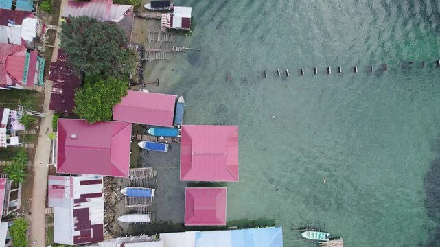Colorful waterfront buildings and boats on bastimentos island, bocas del toro, aerial view