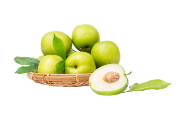 Jojoba half of the fruit lies near a basket with a bunch of fruits isolated