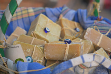 Discover beautiful handmade organic soap bars presented in a wicker basket with colorful fabrics