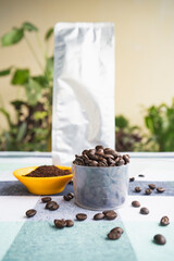 Coffee Pouch Packet Mockup with Espresso Americano and Cofee Beans, Grinded Coffee in Garden Table