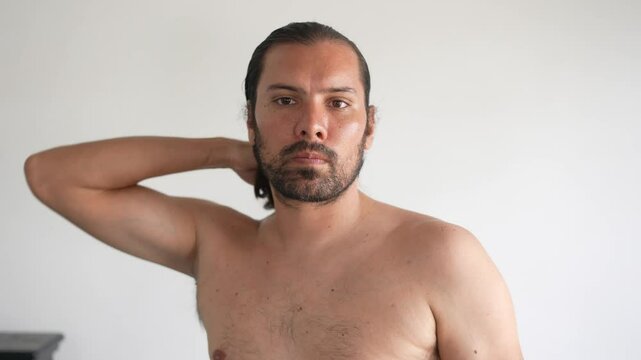 handsome, long-haired latin man in the bathroom