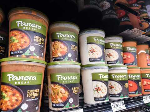 Shelf stocked with Panera Bread soups in a supermarket