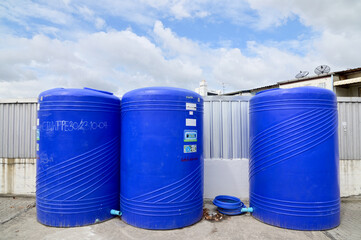 BANGKOK, THAILAND - July 29, 2024: Rows of large blue plastic water tanks, holding 3000 liters, is...
