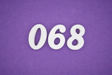 The numbers are made of white paint wood, placed on the background as a purple paper.