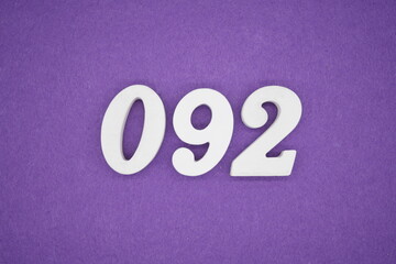 The numbers are made of white paint wood, placed on the background as a purple paper.