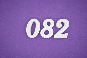 The numbers are made of white paint wood, placed on the background as a purple paper.