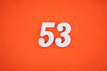 The numbers are made of white painted wood. Placed on the floor was orange paper.