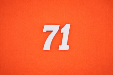 The numbers are made of white painted wood. Placed on the floor was orange paper.