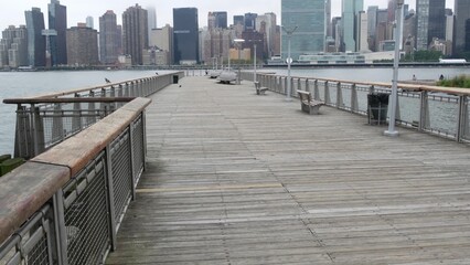 Obraz premium New York City waterfront skyline, Manhattan Midtown buildings, riverfront skyscrapers by East river water. Waterside cityscape view, Gantry Plaza pier, Long Island, Queens. United States architecture.