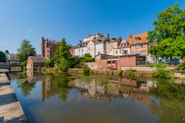 Louviers, France 07 19 2024 : Red brick building along the Eure river in the Center of Louvier in...