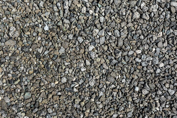 Small pieces of metallurgical slag form a natural background. The texture of slag waste