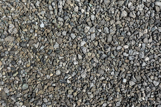Small pieces of metallurgical slag form a natural background. The texture of slag waste