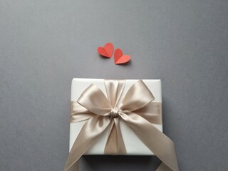 Gift box with red paper hearts