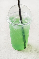 green lemonade in the plastic cup