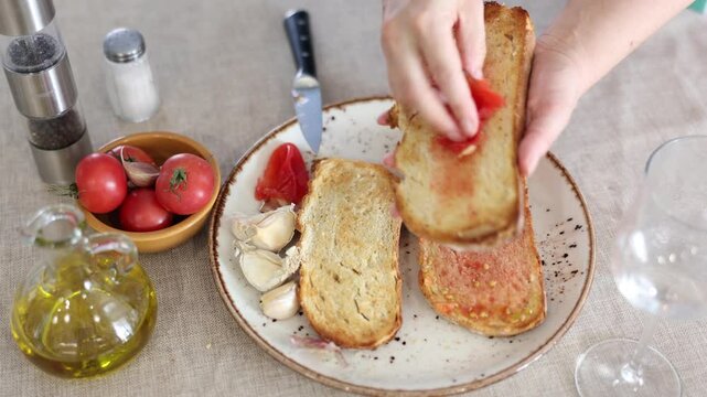 Authentic Spanish Pan con Tomate - cook rubs bread with tomatoes. High quality 4k footage