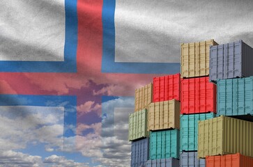 Faroe islands flag and big stack of shipping cargo containers in docks with sky background close up