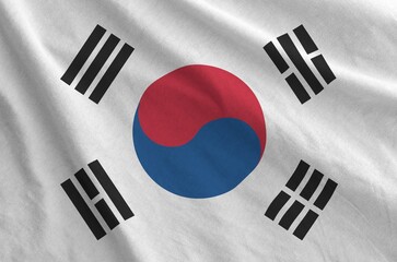 South Korea flag depicted on folded wavy fabric of old cloth close up