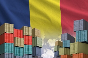 Chad flag and big stack of shipping cargo containers in docks with sky background close up