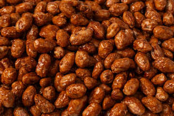 Tasty sweet roasted peanuts as a background.