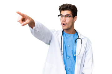 Young doctor man over isolated background pointing away