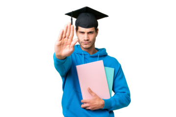 Young university graduate man over isolated background making stop gesture
