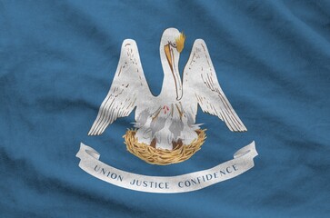 Louisiana US state flag depicted on folded wavy fabric of old cloth close up