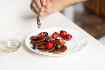 A person is holding a fork, about to eat their healthy and delicious breakfast or snack.