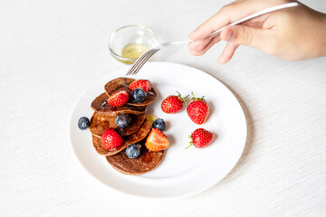 A person is holding a fork, about to eat their healthy and delicious breakfast or snack.