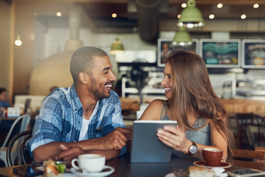Couple, tablet and brunch date in restaurant browsing, hospitality and customer with online survey. People, relationship and together on cafe website, social media and love for lunch blog on app