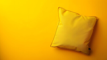 Naklejka premium Pillow on yellow surface from above with space for text