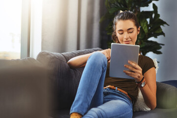 Happy, relax and woman with tablet on sofa for network, connectivity and reading ebook on app....