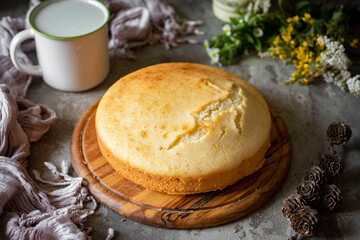 Sweet dessert for breakfast. Vanilla pie on a board on a gray background. A sweet biscuit on a beautiful plate. Close-up