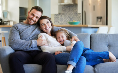 Fototapeta premium Man, woman and kid in home with portrait for wellness, bonding with support for relationship. Happy family, house and hug or care for father with pride, smile together in living room for security