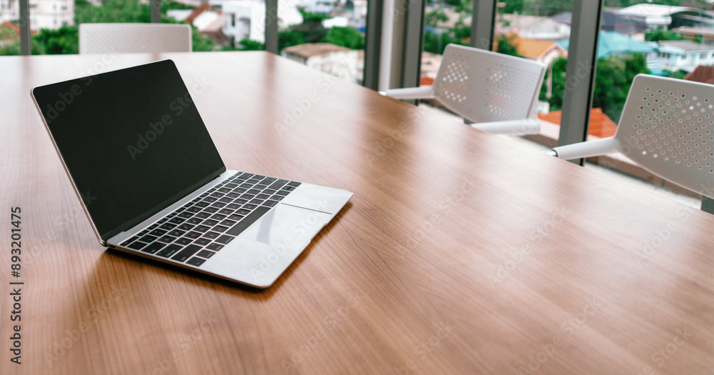 Poster laptop computer with opened lid on table in office workspace. uds