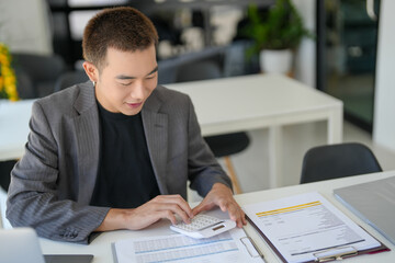 Confident asian business man Auditor or internal revenue service staff checking annual financial statements company Audit  Accounting tax.