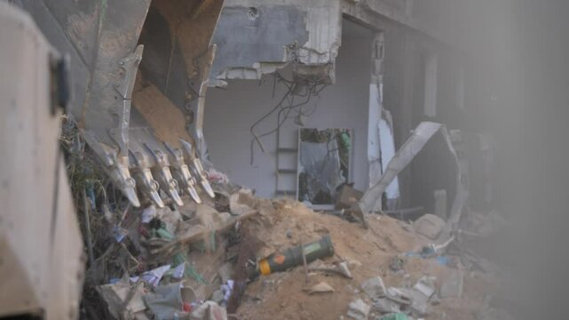Bulldozers clear the rubble of collapsed buildings in the city of Rafah, Palestine