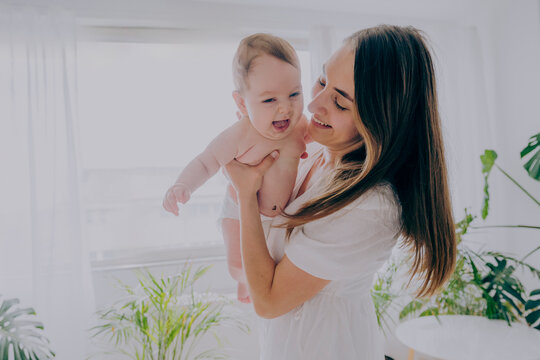 Happy mother spending leisure time with son at home