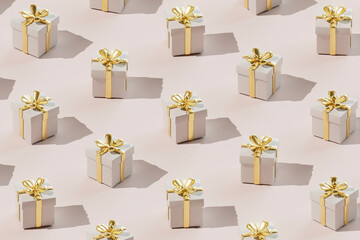 Seamless pattern of elegant gift boxes wrapped in golden ribbon over colored background