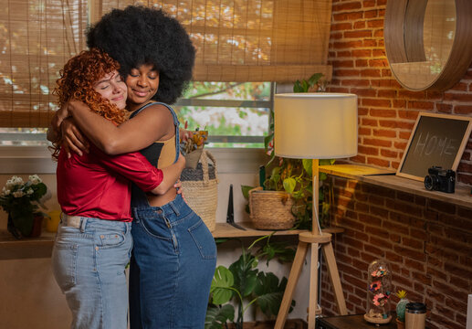 Multiracial young friends embracing and spending leisure time at home