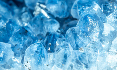 Blue Crystal Mineral Stone. Gems. Mineral crystals in the natural environment. Texture of precious and semiprecious stones. Seamless background with copy space colored shiny surface of precious stones