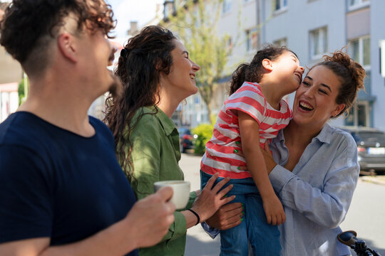 Family and friends spending leisure time at street