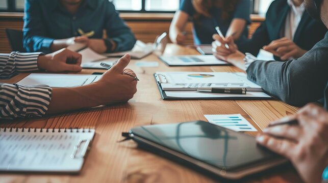 A team meeting with the boss leading the discussion, employees taking notes in their notebooks, a whiteboard filled with plans and schedules, and everyone dressed in professional attire - Powered by Adobe