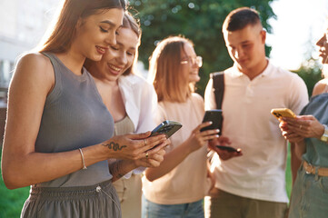 Outside the university. Group of students are together