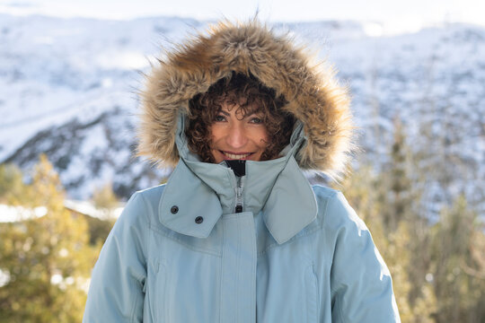 Happy woman in parka coat with fur hood
