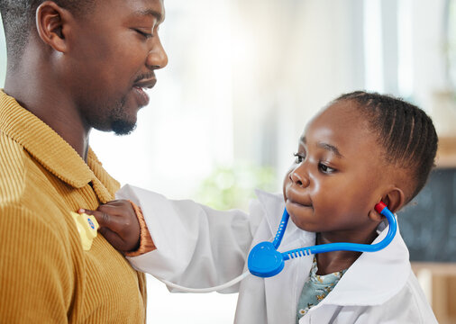 Father, kid and playing doctor with costume or healthcare toys for bonding, pretend or cardiology at home. Black family, dad and child listening to heart beat for nursing game, checkup or career day