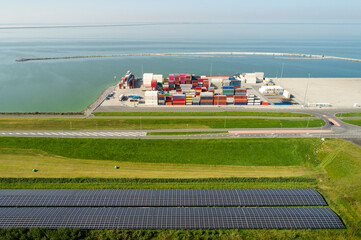Aerial view of solar farm and cargo containers on harbour near sea in Netherlands