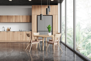 Home kitchen interior with eating table and cooking cabinet. Panoramic window