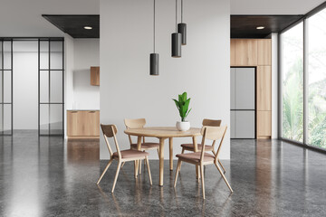 Home kitchen interior with eating table and cooking cabinet. Panoramic window