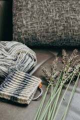 Yarn balls and knitting needles with lavender flowers. Knitting hobby. Striped pattern of wool yarn...